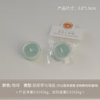 Round tealight candle, dark green (scent: sage and sea salt)
