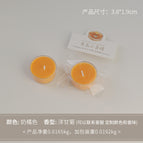 Round tealight candle, milky orange color (scent: chamomile)