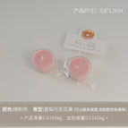 Round tea light candle, dark pink (scent: pear and fig)