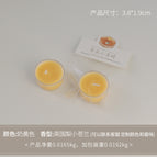Round tealight candle, milky yellow (scent: English pear and freesia)